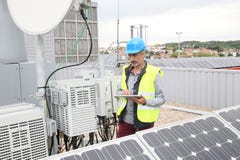 Mature engineer working on solar panels Royalty Free Stock Photo Mature engineer working on solar panels Royalty Free Stock Photo