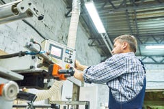 Mature Factory Workers Operating Machines stock photo Mature Factory Workers Operating Machines stock photo