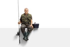 Mature fisherman with a fishing rod sitting on a panel royalty free stock photography Mature fisherman with a fishing rod sitting on a panel royalty free stock photography