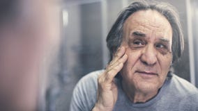 Mature man checking his wrinkles stock photo Mature man checking his wrinkles stock photo