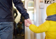 Mature man and his little son looks out the window of the car in the subway in new York stock photography Mature man and his little son looks out the window of the car in the subway in new York stock photography