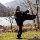 Mature man practicing Tai Chi discipline outdoors royalty free stock photos Mature man practicing Tai Chi discipline outdoors royalty free stock photos