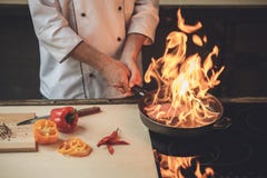 Mature man professional chef cooking meal indoors Royalty Free Stock Photo Mature man professional chef cooking meal indoors Royalty Free Stock Photo