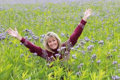 Mature woman in flower field Royalty Free Stock Image Mature woman in flower field Royalty Free Stock Image