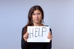 Mature woman holding paper with help lettering royalty free stock images Mature woman holding paper with help lettering royalty free stock images