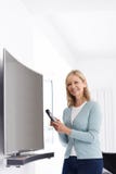 Portrait Of Mature Woman With New Curved Screen Television At Ho Stock Photo Portrait Of Mature Woman With New Curved Screen Television At Ho Stock Photo