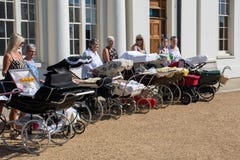 Mature women lined up with collection of vintage prams Royalty Free Stock Photography Mature women lined up with collection of vintage prams Royalty Free Stock Photography