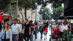 MAY 9, 2017, BAKU, AZERBAIJAN: People stroll in square of Baku, a crowd of people walk the streets of the city. stock footage MAY 9, 2017, BAKU, AZERBAIJAN: People stroll in square of Baku, a crowd of people walk the streets of the city. stock footage