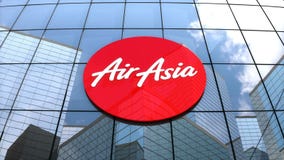 Editorial, AirAsia Berhad logo on glass building.