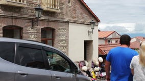 MAY 2017, SIGNAGHI, GEORGIA:Tourists pass along the streets by souvenir shops.The beautiful Georgian town of Sighnaghi stock footage MAY 2017, SIGNAGHI, GEORGIA:Tourists pass along the streets by souvenir shops.The beautiful Georgian town of Sighnaghi stock footage