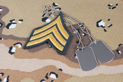 May 12, 2018. US ARMY Sergeant rank patch and dog tags on Desert Battle Dress Uniform background royalty free stock image May 12, 2018. US ARMY Sergeant rank patch and dog tags on Desert Battle Dress Uniform background royalty free stock image