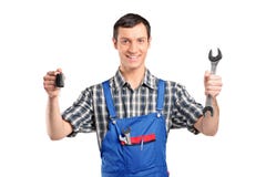 Mechanic In Uniform Holding A Car Key And Wrench Royalty Free Stock Photos Mechanic In Uniform Holding A Car Key And Wrench Royalty Free Stock Photos