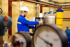 Mechanical worker adjusting pressure manometers on industrial equipment royalty free stock photo Mechanical worker adjusting pressure manometers on industrial equipment royalty free stock photo