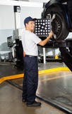 Mechaniker-Adjusting Wheel Alignment-Maschine lizenzfreies stockfoto Mechaniker-Adjusting Wheel Alignment-Maschine lizenzfreies stockfoto