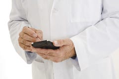 Caucasian doctor wearing a white lab coat using PDA Royalty Free Stock Images Caucasian doctor wearing a white lab coat using PDA Royalty Free Stock Images