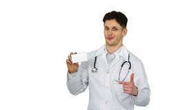 Medical doctor holding a box of pills promoting them and dancing on white background. stock video footage Medical doctor holding a box of pills promoting them and dancing on white background. stock video footage