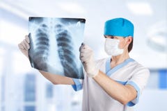 Medical doctor looking at x-ray picture of lungs l