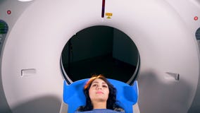 Medical MRI Scan being done on a young woman.