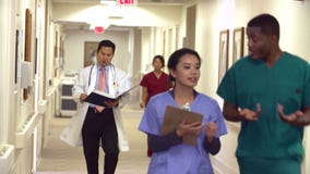 Medical Staff Along Hospital Corridor