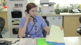Medical Staff Working At Nurses Station
