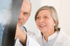 Medical team senior doctors look at x-ray stock photo Medical team senior doctors look at x-ray stock photo