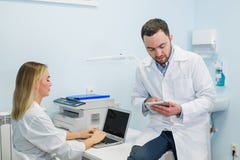 Medical team with tablet pc standing and talking at the hospital stock photography Medical team with tablet pc standing and talking at the hospital stock photography