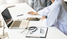 medicine doctor explain diagnosis to doctor team holding and showing clipboard exploring important document. royalty free stock images medicine doctor explain diagnosis to doctor team holding and showing clipboard exploring important document. royalty free stock images