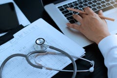 Medicine doctor. Stethoscope with heartbeat report, analyzing checkup on laptop royalty free stock photos Medicine doctor. Stethoscope with heartbeat report, analyzing checkup on laptop royalty free stock photos