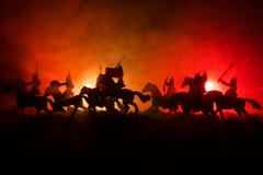 Medieval battle scene with cavalry and infantry. Silhouettes of figures as separate objects, fight between warriors on dark toned stock photos Medieval battle scene with cavalry and infantry. Silhouettes of figures as separate objects, fight between warriors on dark toned stock photos