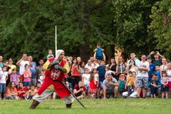Medieval Knight In The Red Suit With A Sword Shows Knightly Skills On At The International Festival Of Knights Royalty Free Stock Image Medieval Knight In The Red Suit With A Sword Shows Knightly Skills On At The International Festival Of Knights Royalty Free Stock Image