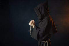 Medieval monk praying with closed eyes stock photo Medieval monk praying with closed eyes stock photo
