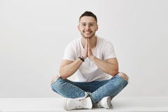 Meditation and emotions concept. Attractive stylish young male with beard, wearing glasses and trendy outfit, sitting royalty free stock photo Meditation and emotions concept. Attractive stylish young male with beard, wearing glasses and trendy outfit, sitting royalty free stock photo