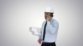 Engineer talking on phone with paperwork on gradient background. stock footage Engineer talking on phone with paperwork on gradient background. stock footage