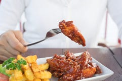 Meisje die kippenvleugel en chips eten stock afbeeldingen Meisje die kippenvleugel en chips eten stock afbeeldingen