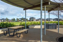 Melbourne, VIC/Australia-June 25th 2020: a well-shaded public resting area with a picnic table and the BBQ facility in a suburban