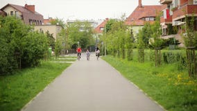 Membri della famiglia felice che spendono insieme tempo all'aperto Hanno molto divertimento che guida sulle bici stock footage Membri della famiglia felice che spendono insieme tempo all'aperto Hanno molto divertimento che guida sulle bici stock footage