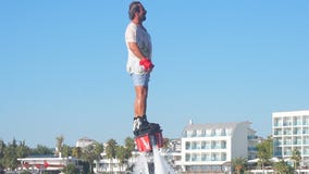 Men Fly Board flying summer vacation. Flyboard is a aerial machine for a personal watercraft which allows propulsion