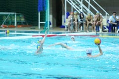 Men play water polo in pool