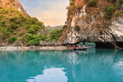 Men rowing sampan with tourist cruising along beautiful limestone rocks in Halong bay. royalty free stock photo Men rowing sampan with tourist cruising along beautiful limestone rocks in Halong bay. royalty free stock photo