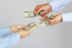 Men's hands give money american hundred dollar bills to boy hands. Businessman give money to business boy. Father and son. Royalty Free Stock Photo Men's hands give money american hundred dollar bills to boy hands. Businessman give money to business boy. Father and son. Royalty Free Stock Photo