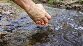 Men`s hands splashing in the stream. stock video Men`s hands splashing in the stream. stock video