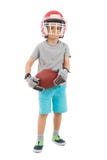 Menino no capacete dos esportes que guarda o rugby fotografia de stock Menino no capacete dos esportes que guarda o rugby fotografia de stock