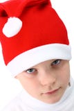Menino pequeno no chapéu de Santa isolado no branco Fotografia de Stock Royalty Free Menino pequeno no chapéu de Santa isolado no branco Fotografia de Stock Royalty Free