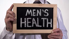 Mens health written on blackboard in urology doctor hands, reproductive medicine royalty free stock images Mens health written on blackboard in urology doctor hands, reproductive medicine royalty free stock images