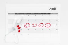 Menstrual period concept. Menstruation calendar with hygienic tampons and pills on white background top view stock images Menstrual period concept. Menstruation calendar with hygienic tampons and pills on white background top view stock images
