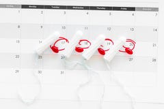 Menstrual period concept. Menstruation calendar with hygienic tampons and pills on white background top view royalty free stock photography Menstrual period concept. Menstruation calendar with hygienic tampons and pills on white background top view royalty free stock photography