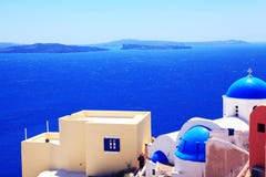 Mer et maisons blanches avec les toits bleus de Santorini photo libre de droits Mer et maisons blanches avec les toits bleus de Santorini photo libre de droits