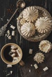 Meringue on a vintage silver plate with coffee and vintage twisted spoon. Royalty Free Stock Photos Meringue on a vintage silver plate with coffee and vintage twisted spoon. Royalty Free Stock Photos