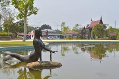 The Mermaid Statue in the water and community background royalty free stock photo The Mermaid Statue in the water and community background royalty free stock photo