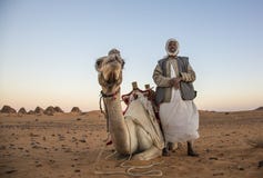 Man with his camel in a desert in Sudan Stock Image Man with his camel in a desert in Sudan Stock Image